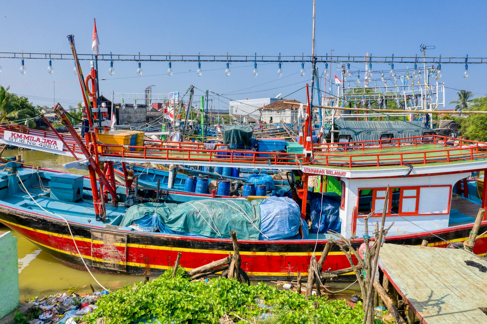 Wooden phinisi schooners docked at Sunda Kelapa harbor