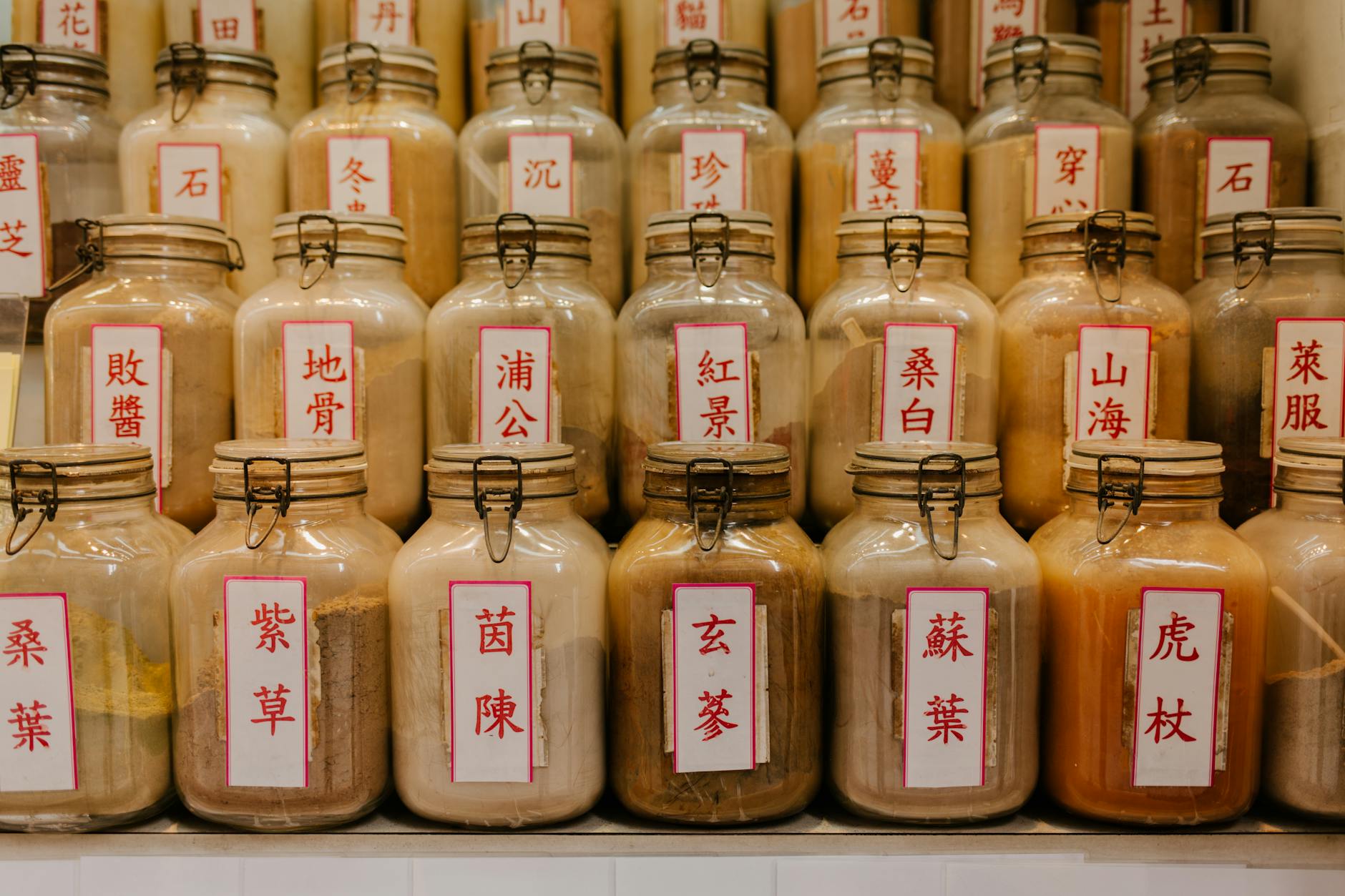 Traditional Chinese herbal medicine shop with jars and dried herbs
