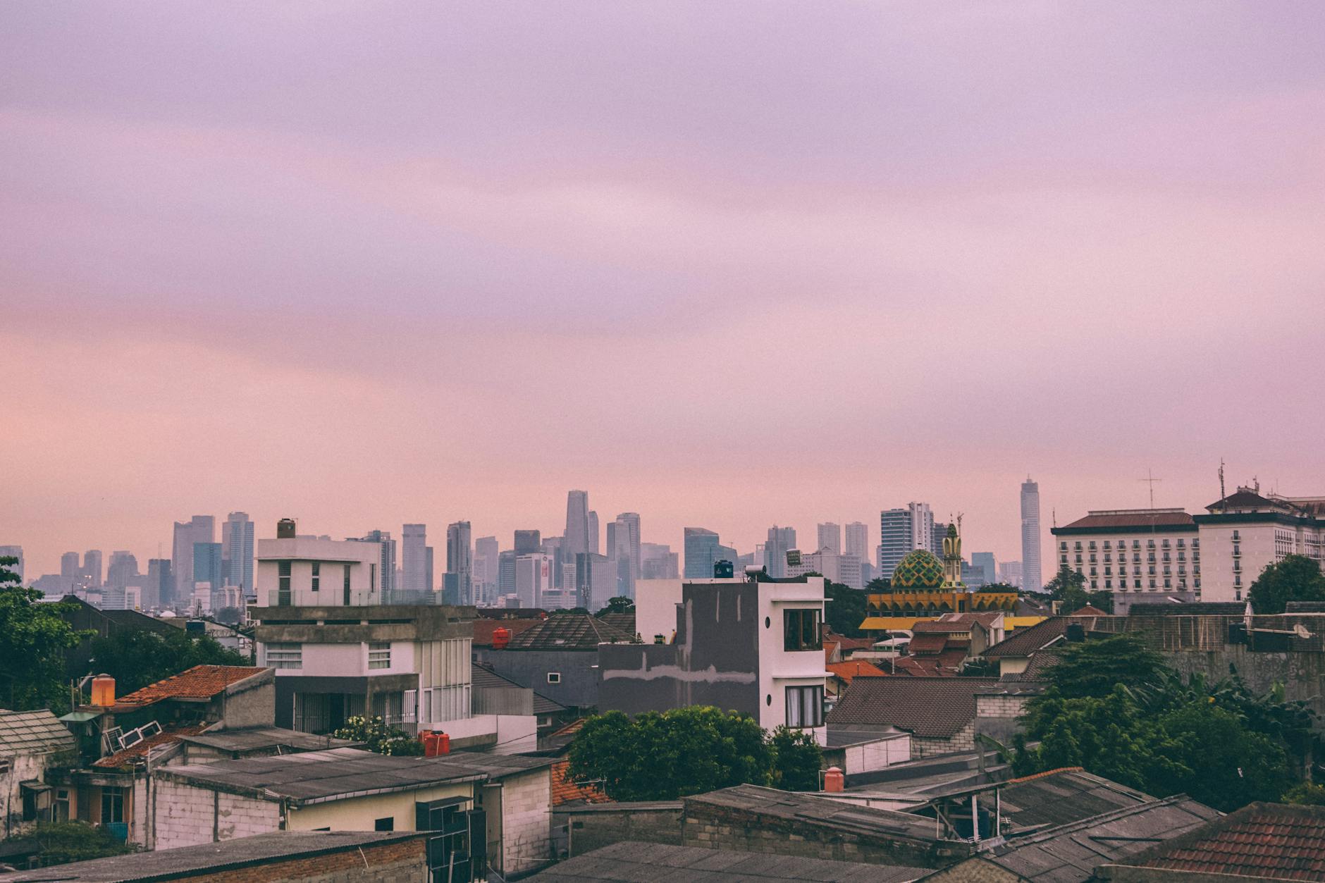Jakarta rooftop bar at sunset overlooking the city