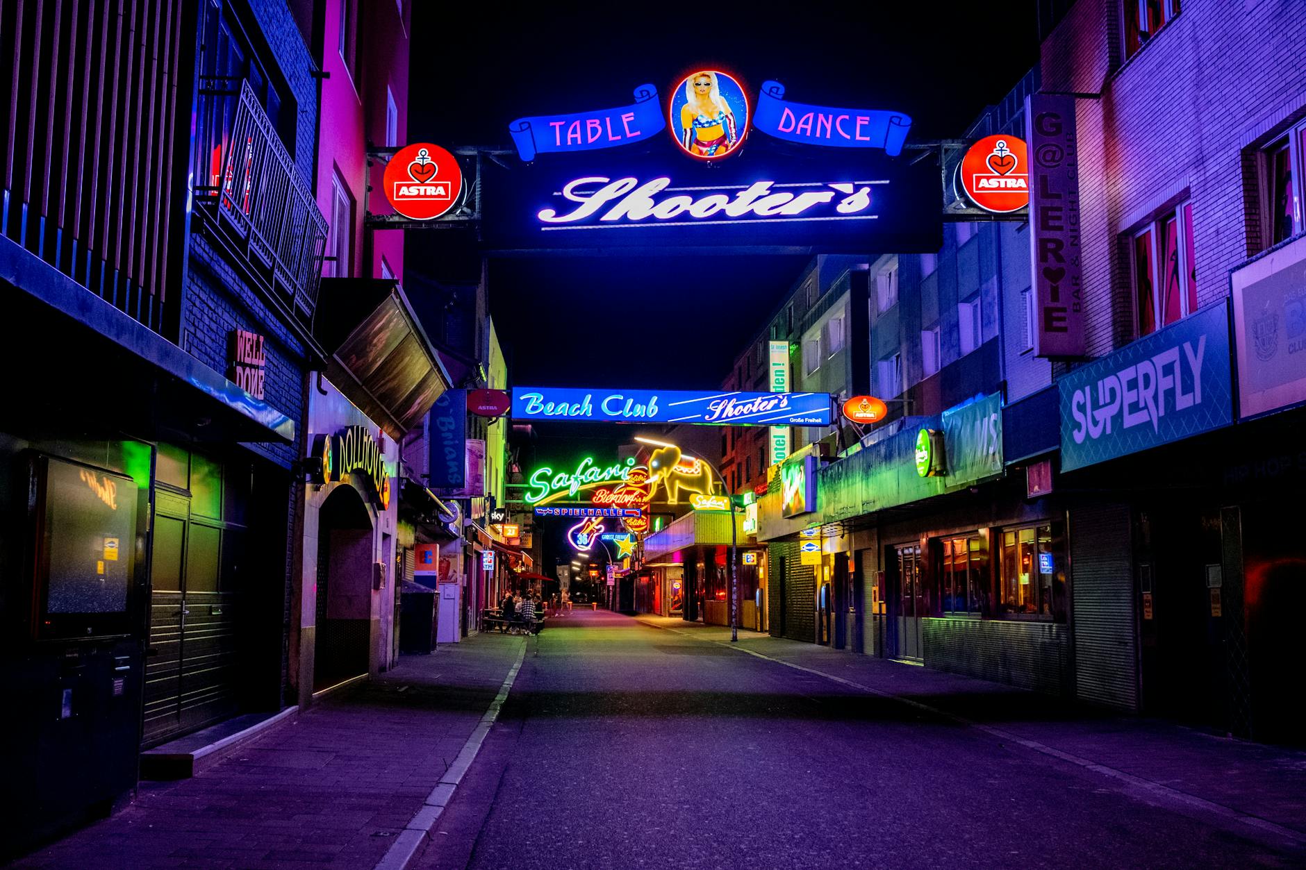 Jakarta nightlife district with neon signs and bars