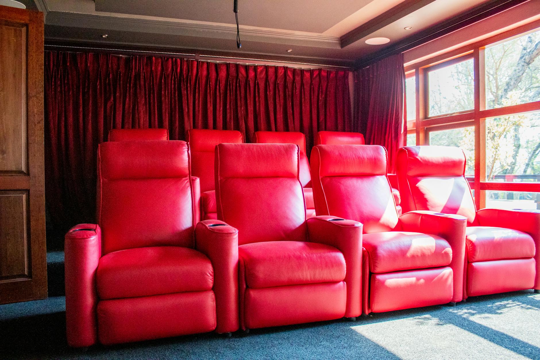 Premium cinema with reclining red seats and large screen