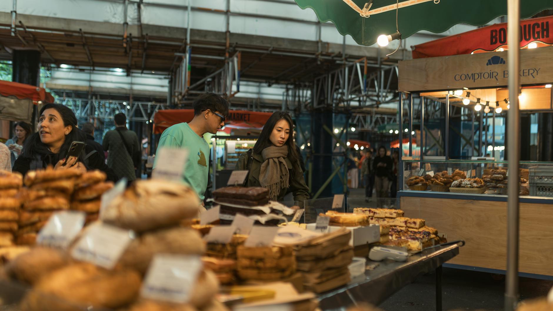 Trendy food market with colorful stalls and young patrons