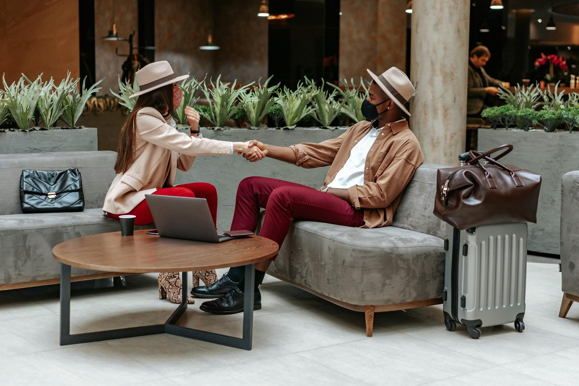 Modern hotel lobby with travelers and luggage