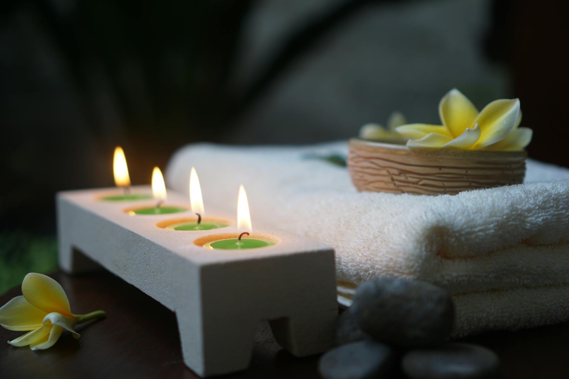 Luxurious spa room with treatment table flowers and soft lighting