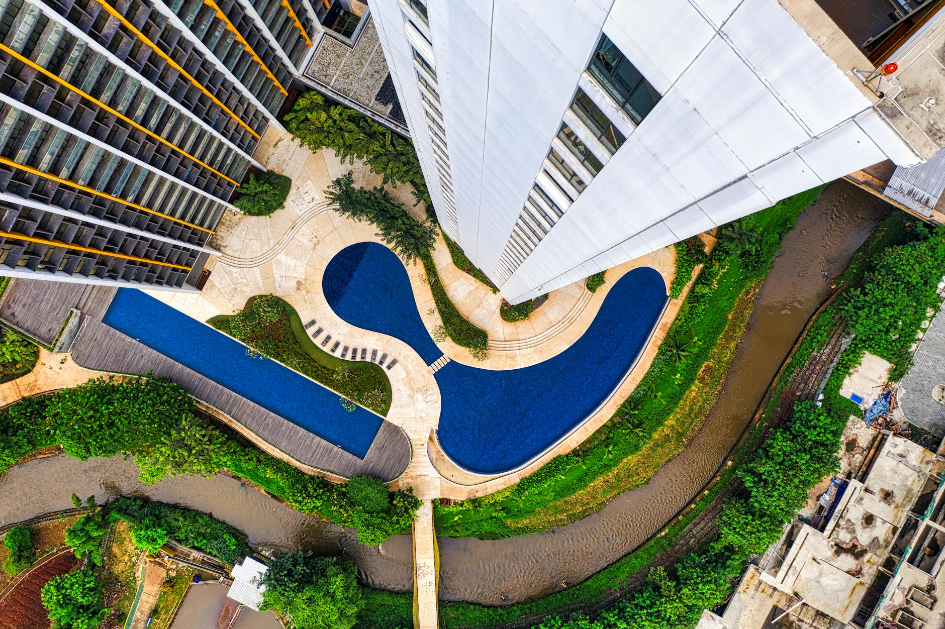 Rooftop swimming pool at a Jakarta hotel with city skyline views