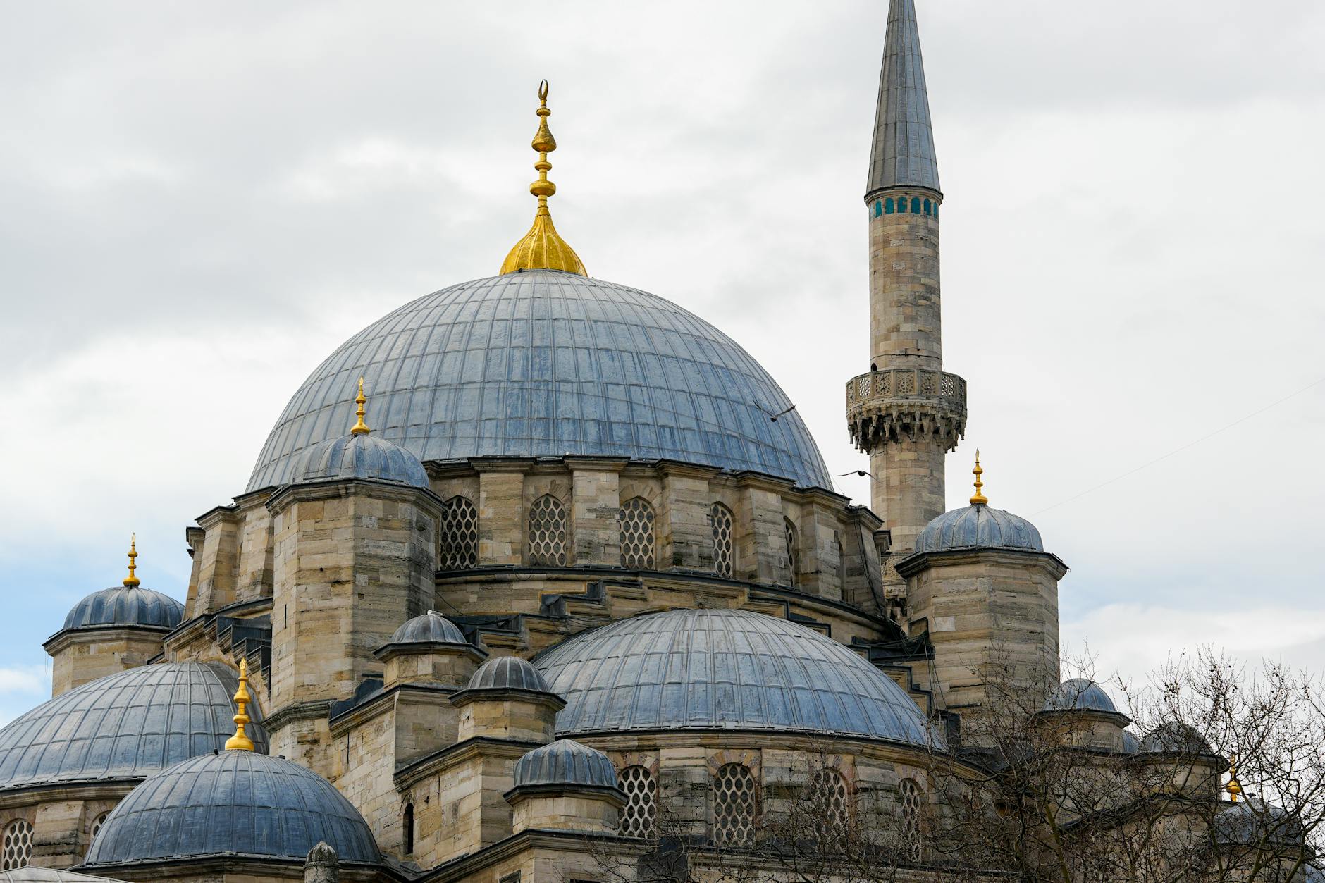 Mosque dome and minaret against blue sky