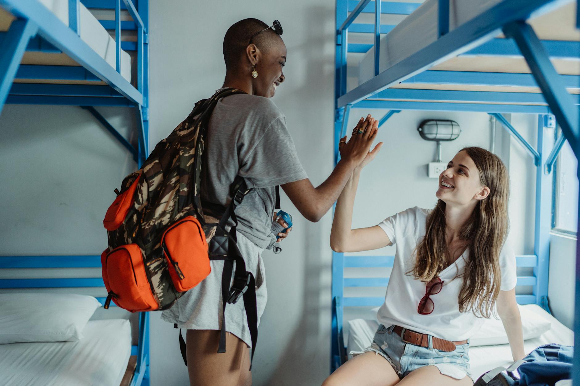 A clean budget hostel dormitory room in Jakarta with bunk beds and lockers
