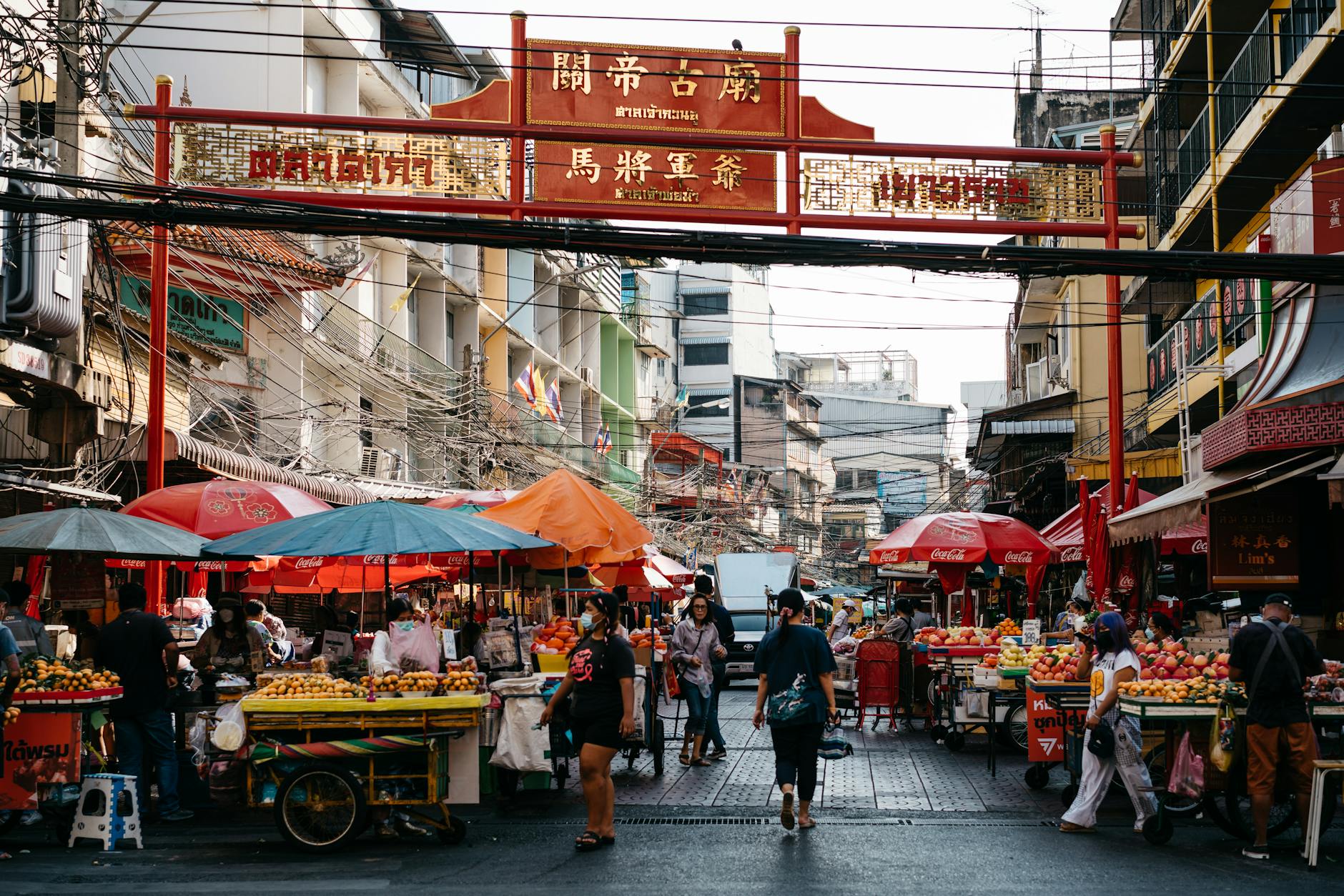 Indonesian Chinatown market with vendors and traditional shophouses
