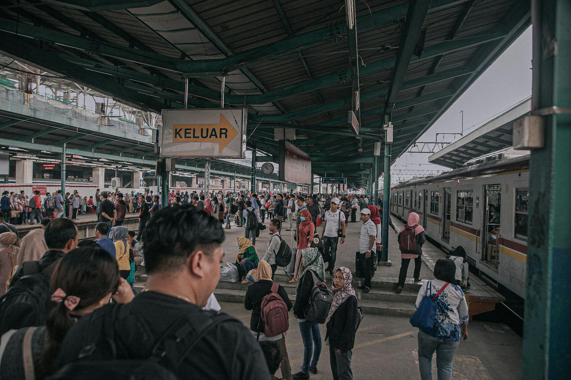 Indonesian train station platform busy commuter rush