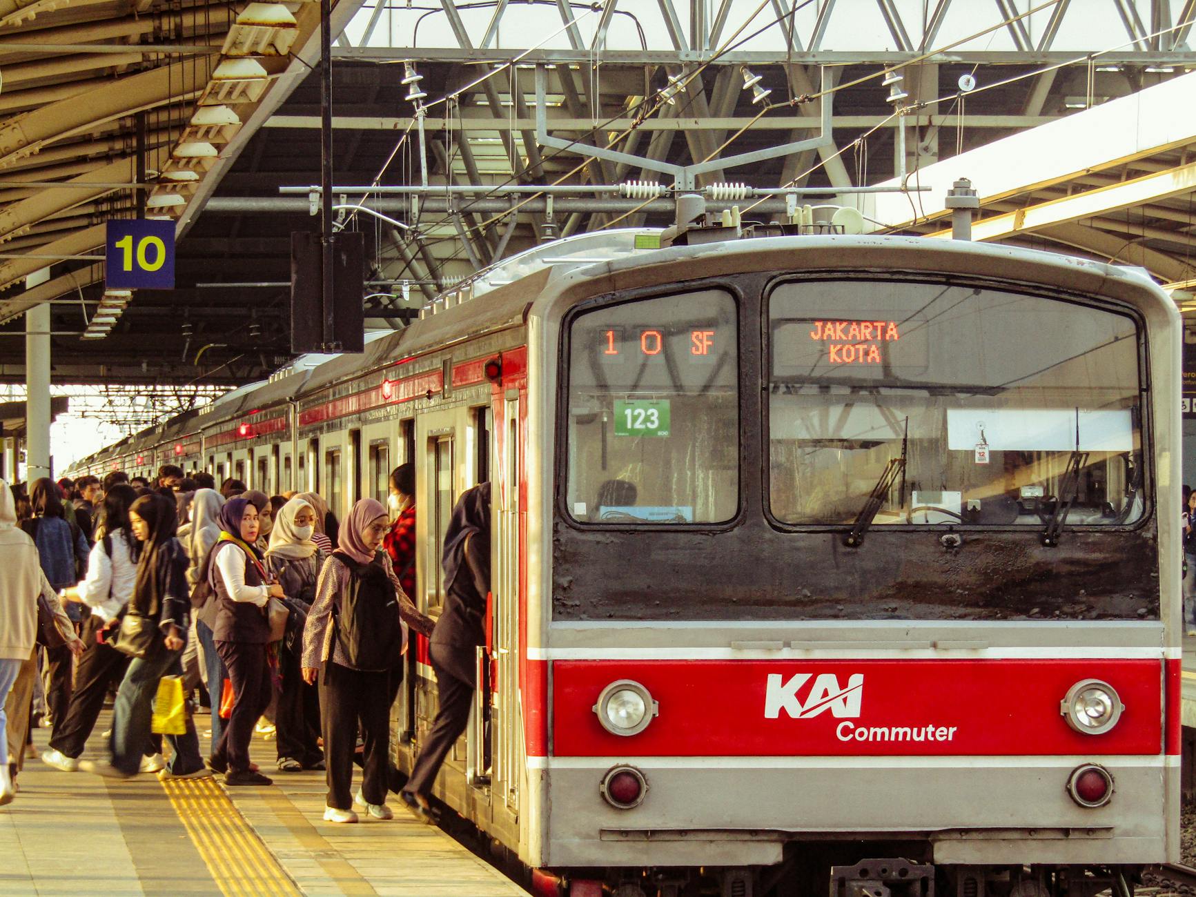 Indonesian commuter train rush hour crowded passengers