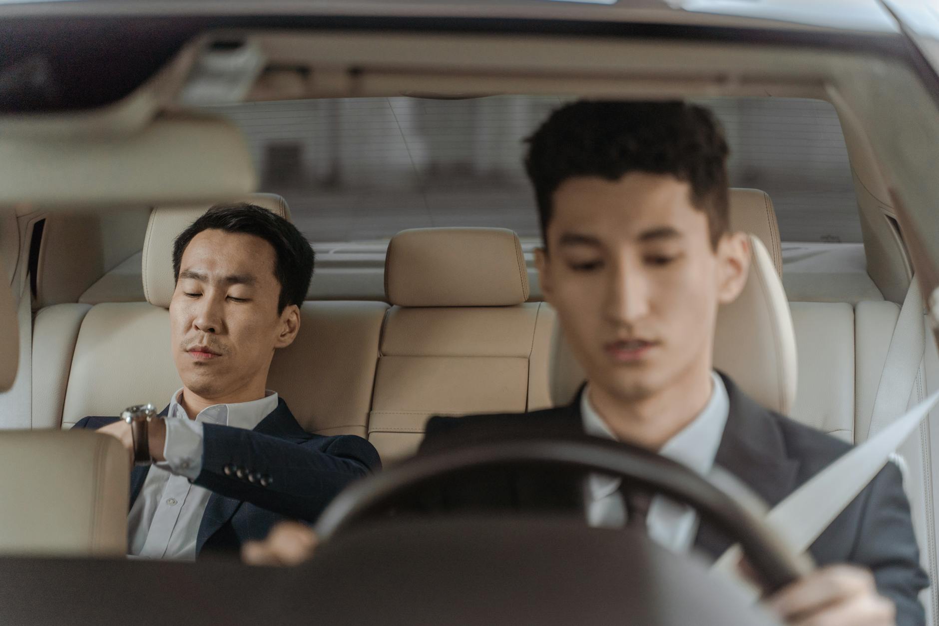 Indonesian professional driver waiting beside vehicle
