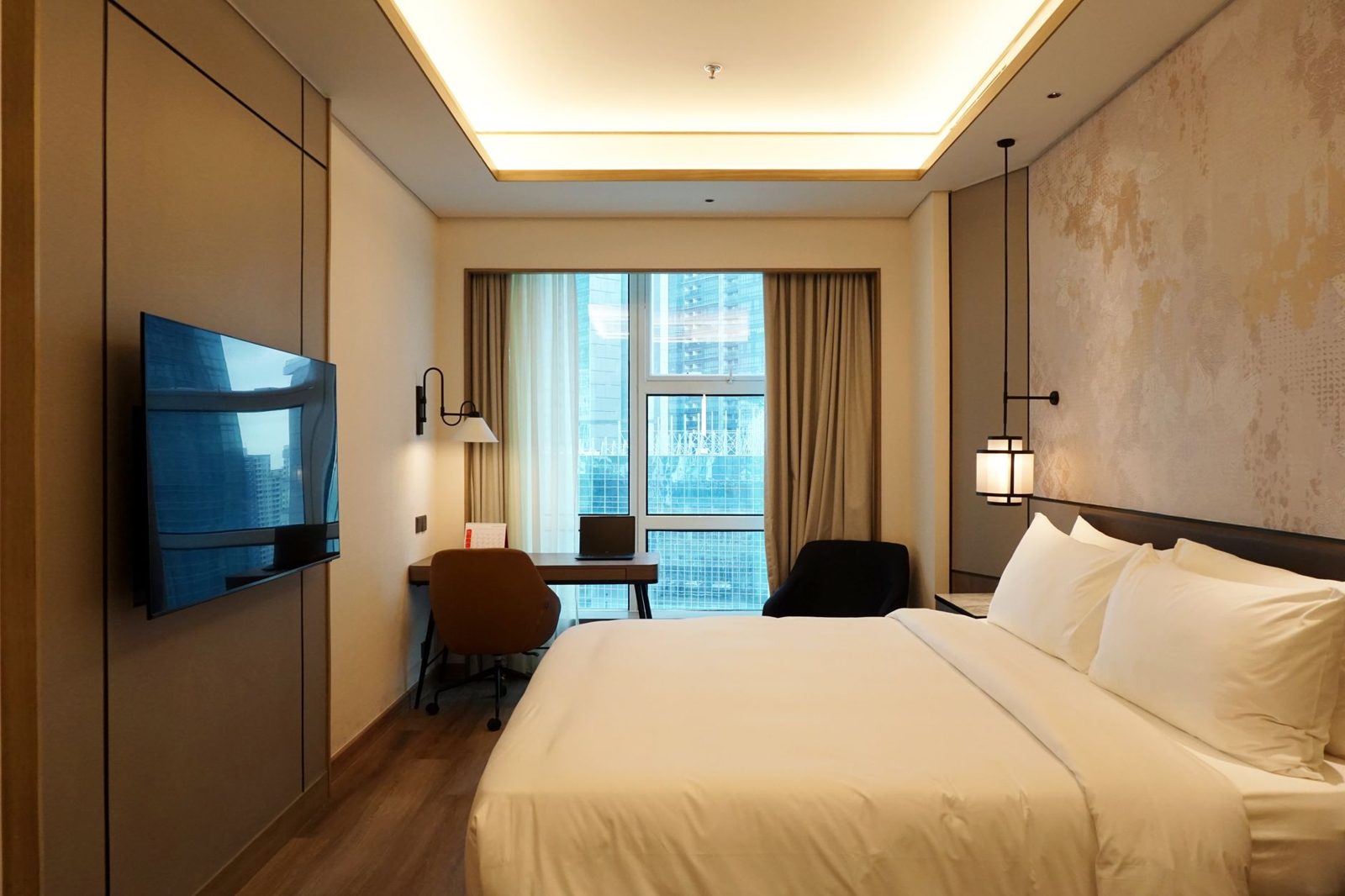 Business hotel room with work desk overlooking Jakarta