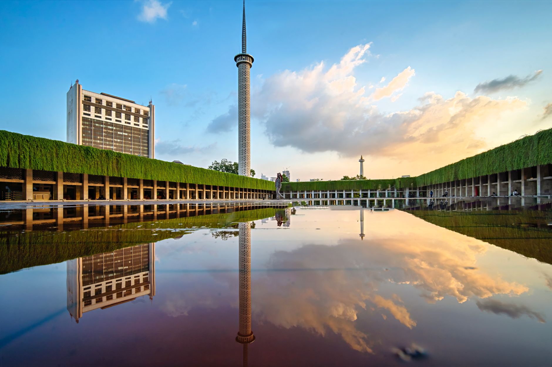 The Monas obelisk reflected in water at Merdeka Square at sunset, a Central Jakarta guide landmark