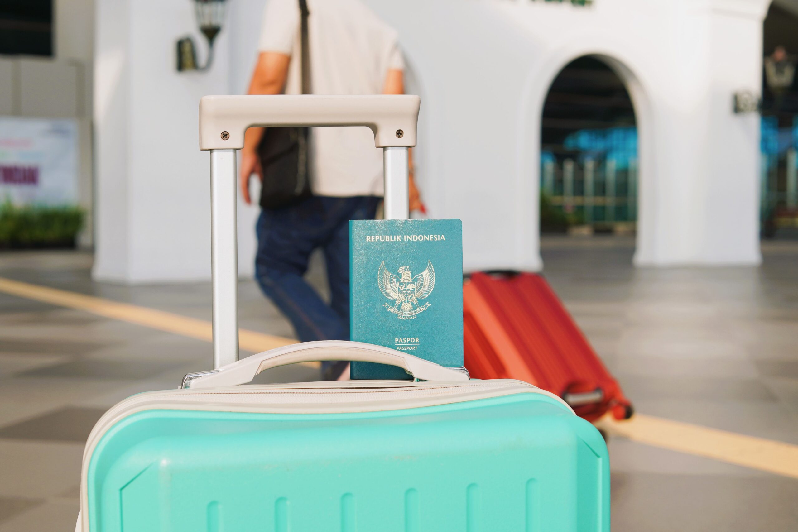 Indonesian passport resting on a suitcase, a reminder to carry proof of onward travel to satisfy Indonesia visa requirements