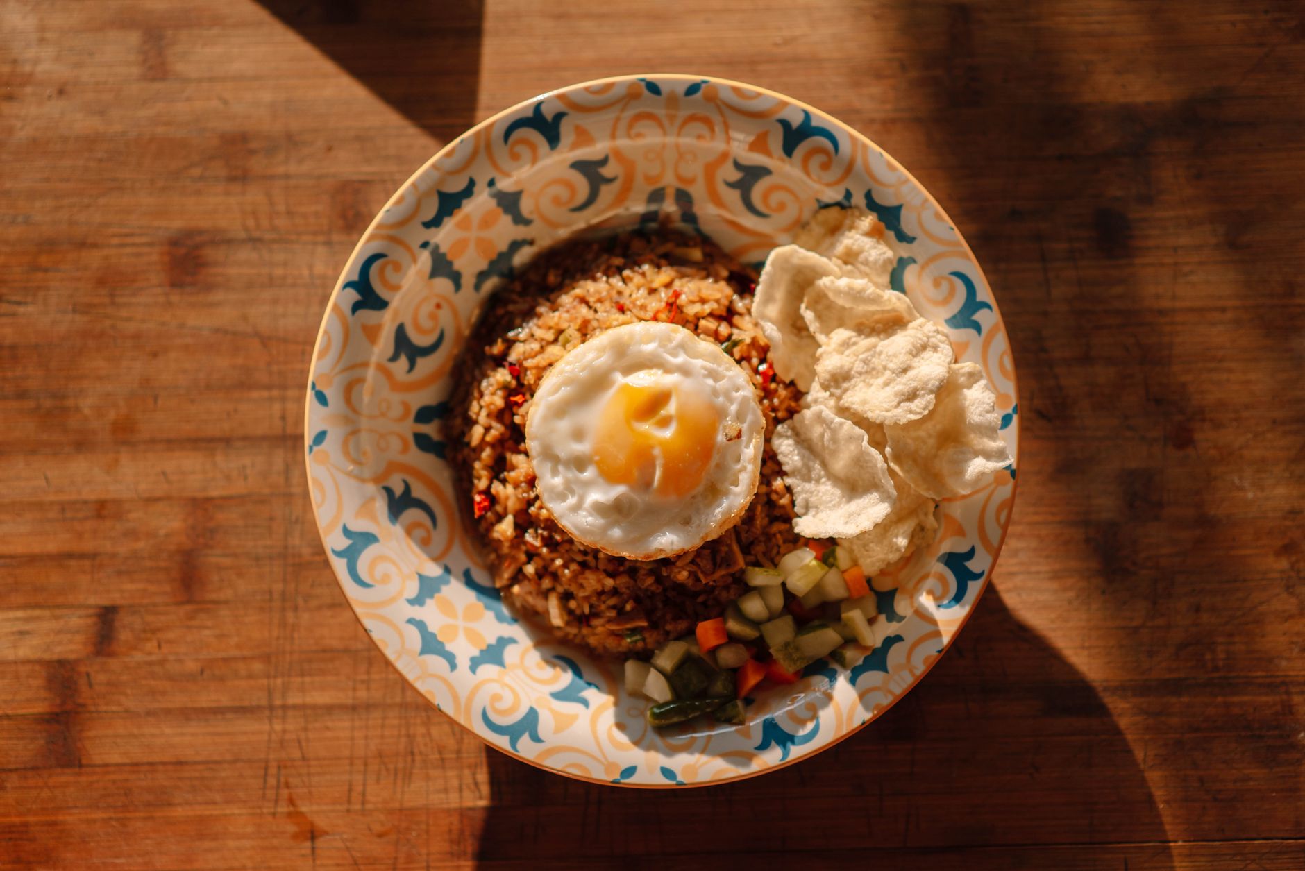 Plate of nasi goreng with fried egg and krupuk, a Jakarta late night eats staple