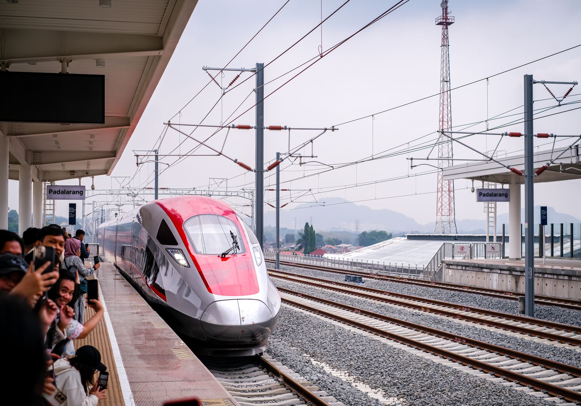 A red and silver high-speed train arriving at Padalarang station on the Jakarta to Bandung line