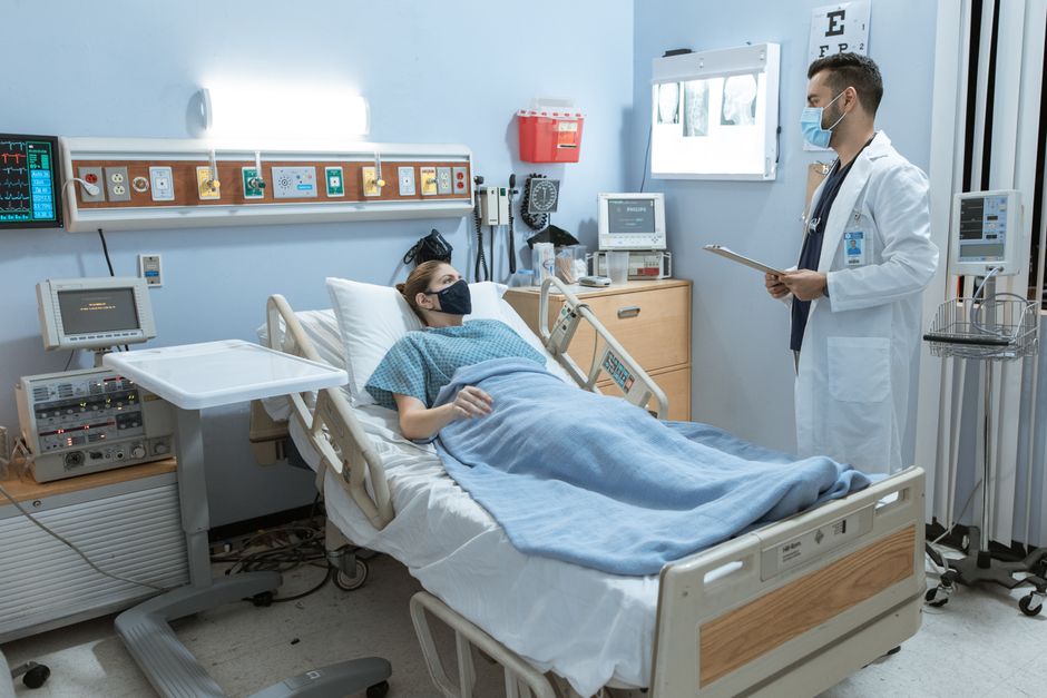 Patient being treated in a hospital room, illustrating the medical cover a jakarta travel insurance policy needs to include