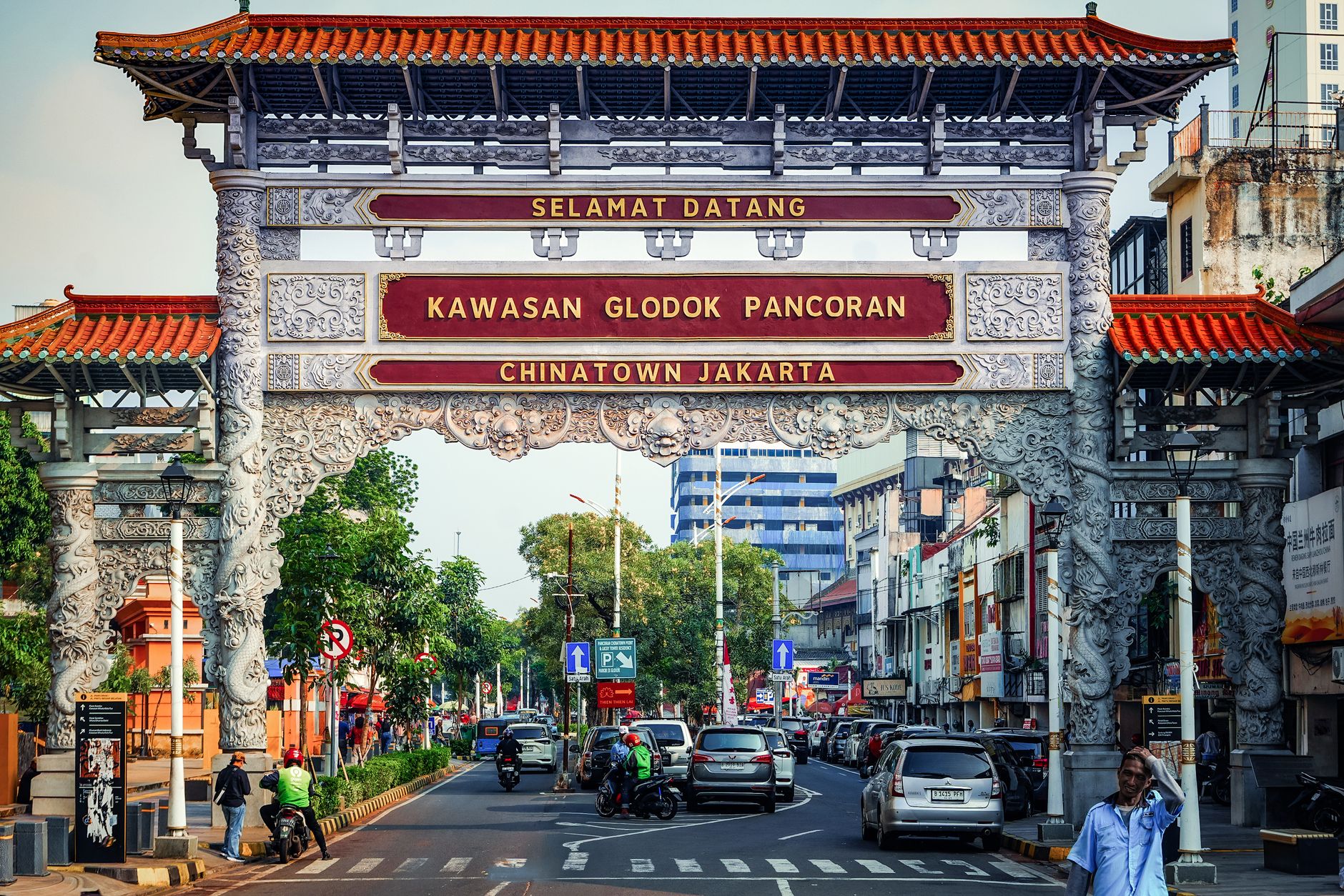 The ornate red and grey gateway marking the entrance to Glodok Pancoran Chinatown next to Kota Tua