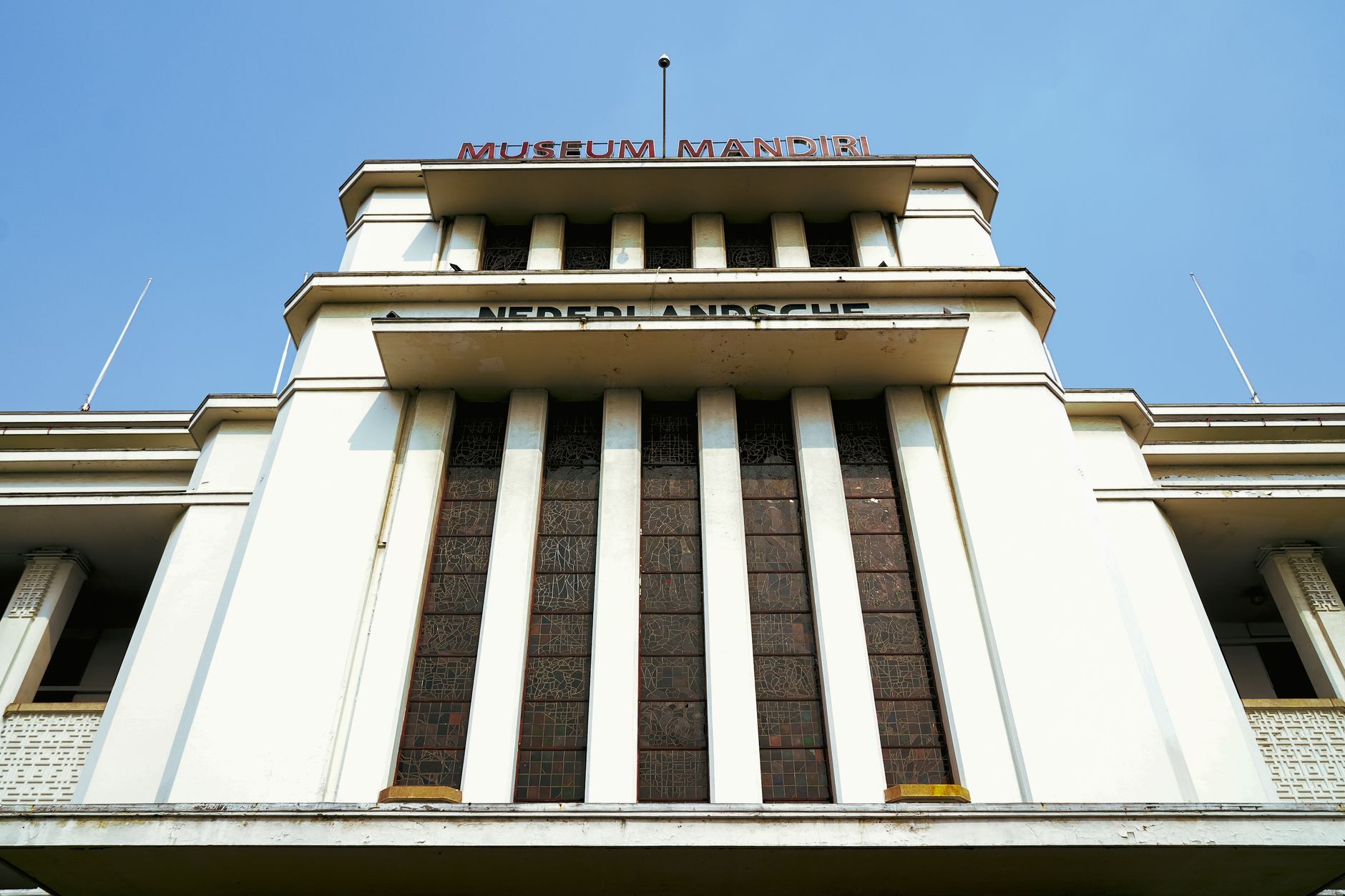 The art deco facade of Museum Bank Mandiri on Jalan Pintu Besar Utara in the Kota Tua neighborhood guide area