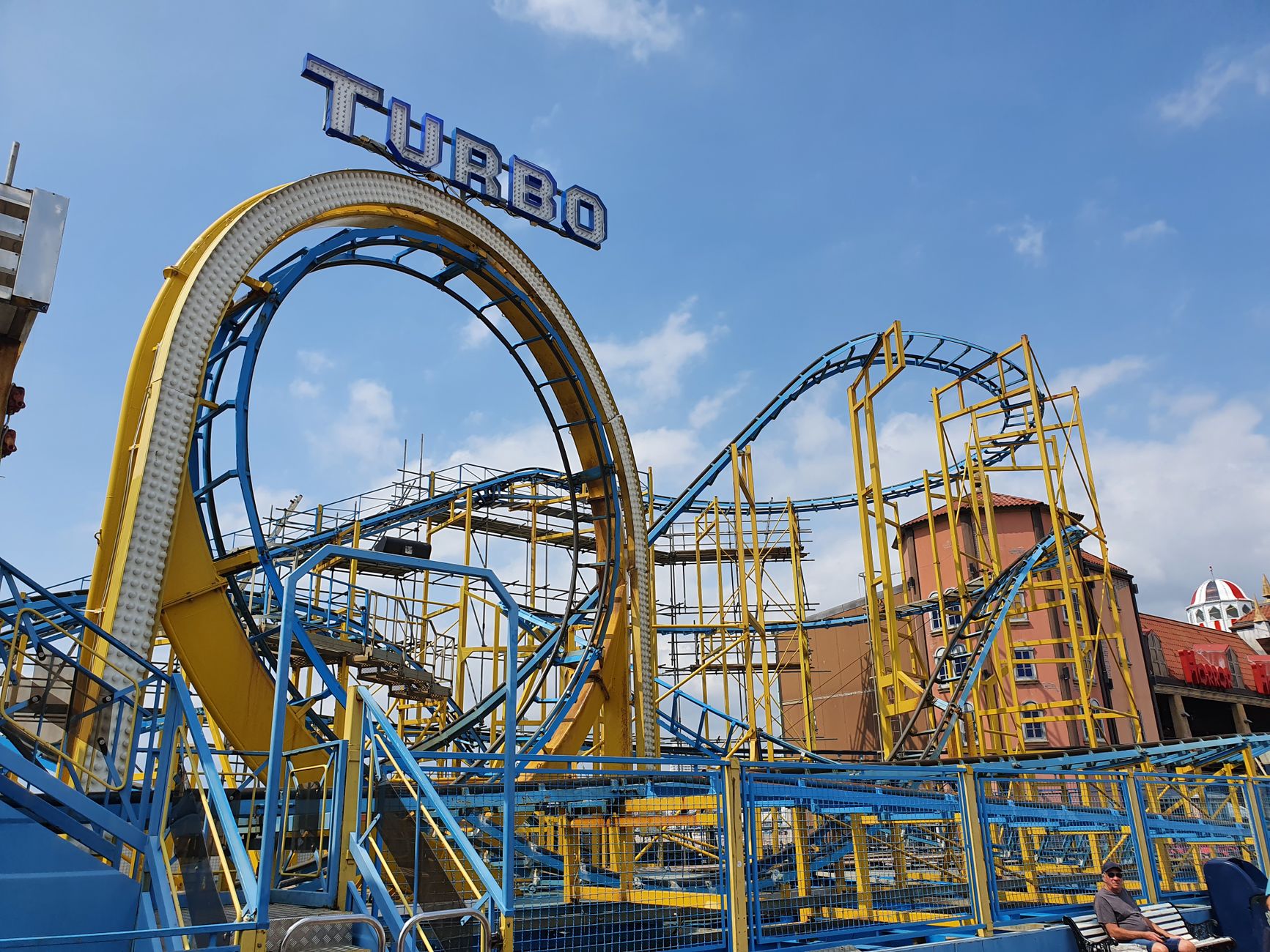 A yellow and blue roller coaster track at a theme park of the kind found at Dunia Fantasi in Ancol