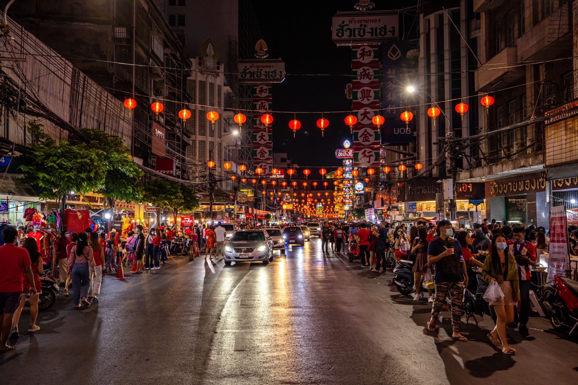 Red lanterns strung above a crowded evening food street, as at Pantjoran PIK in North Jakarta