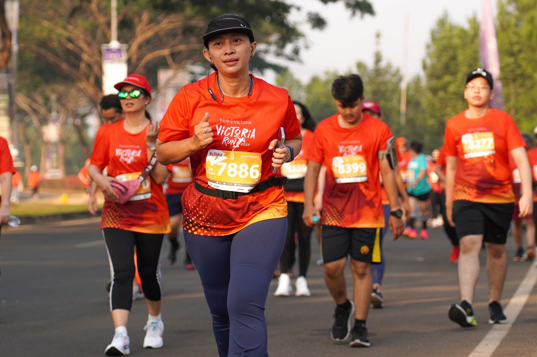 A crowd of runners in race bibs on a Jakarta road, the kind of event the Senayan area guide district hosts most weekends