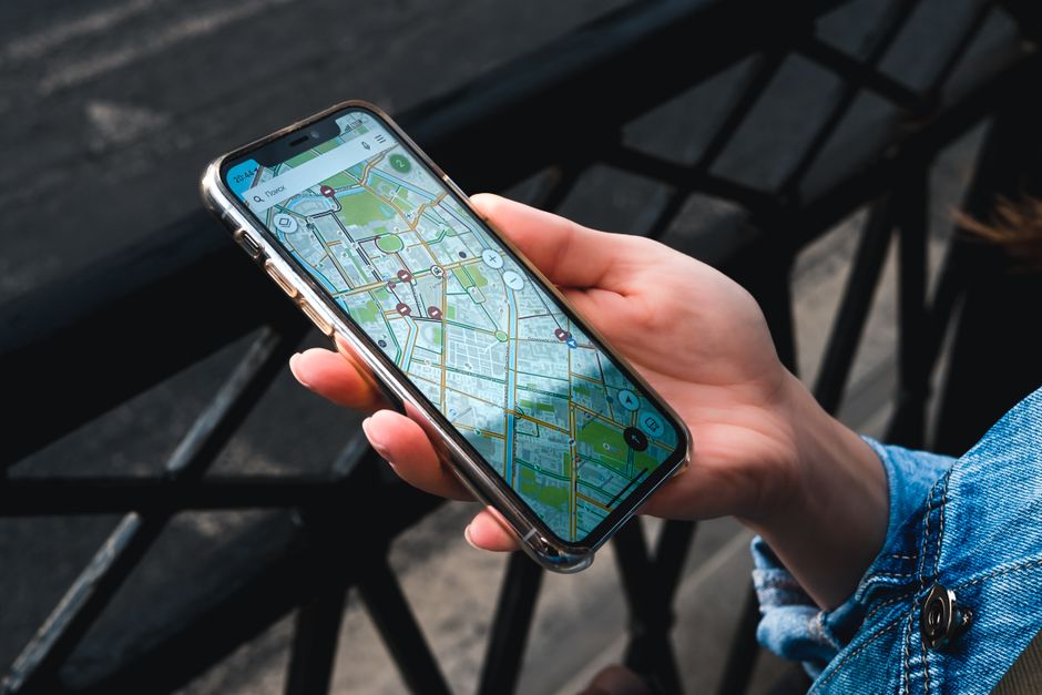 Hand holding a smartphone open to a navigation map, the kind of data use an Indonesia eSIM needs to handle on arrival