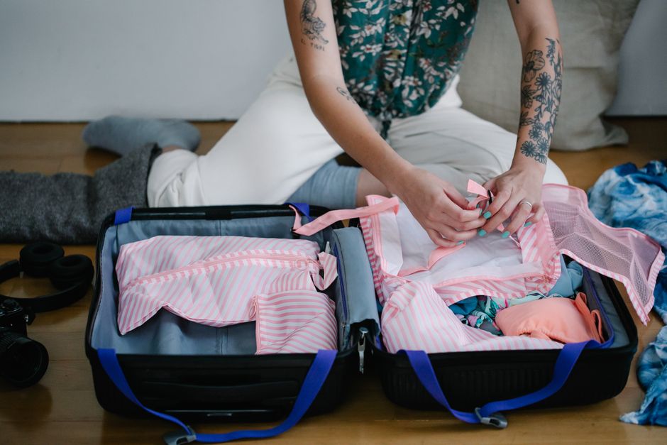 Open suitcase being packed with lightweight clothing for a humid Jakarta climate