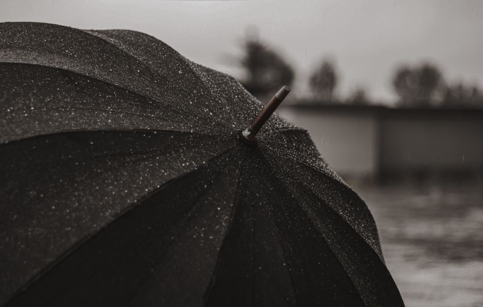 Close-up of an umbrella in heavy rain, typical of a Jakarta afternoon downpour
